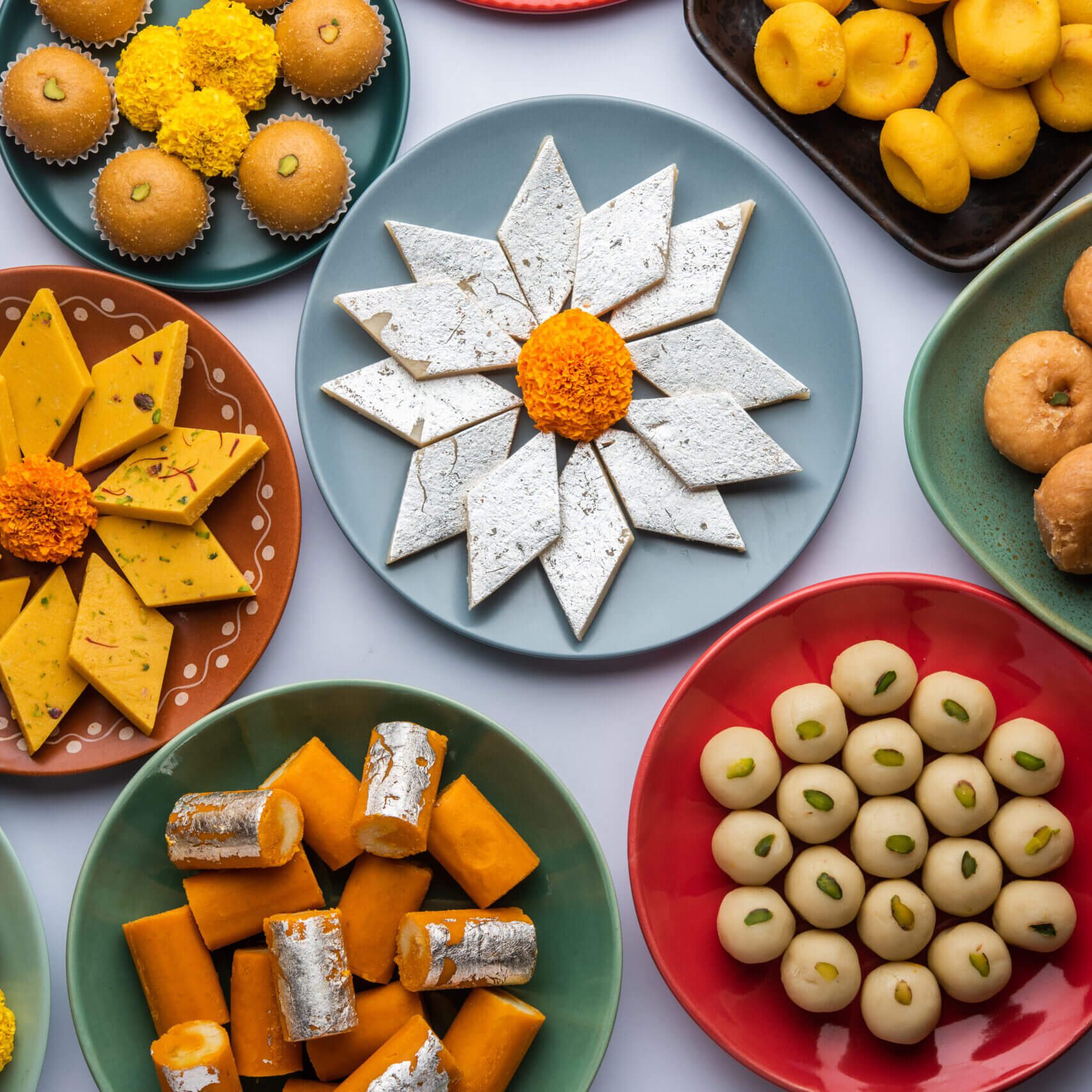 Group of Indian assorted sweets or mithai with diya